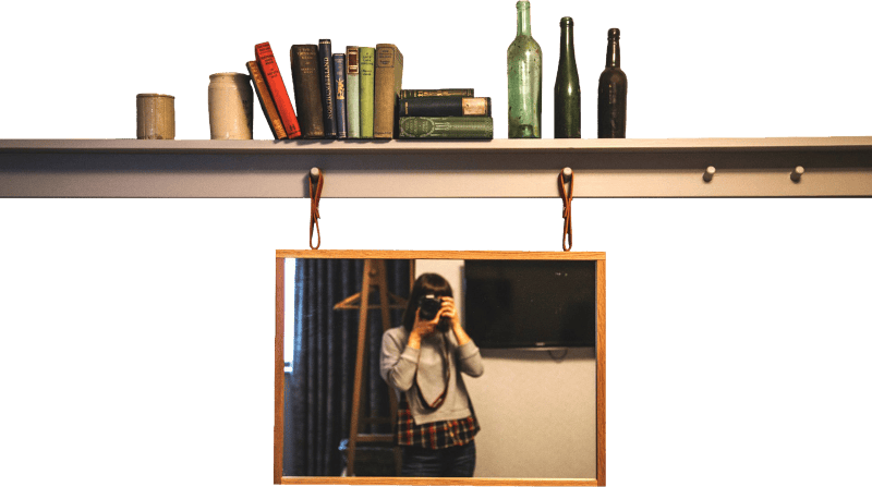 Woman taking photography in front of the mirror