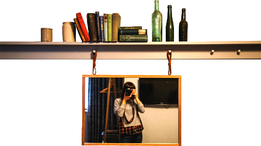 Woman taking photography in front of the mirror