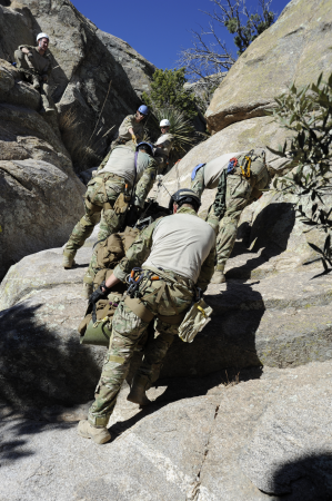 U.S. Airmen assigned to the 48th Rescue Squadron navigate a cliff while moving a simulated patient up the rugged terrain during high angle, rope rescue training at Mount Lemmon near Tucson, Ariz., Feb. 12 140212-F-WQ860-087