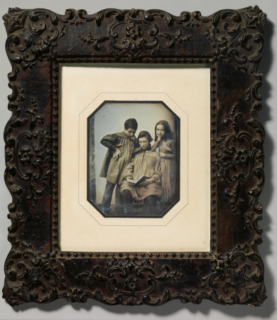 [Three Children, One Seated Holding an Open Book, the Other Two Standing, in Front of a Light Background], circa 1845