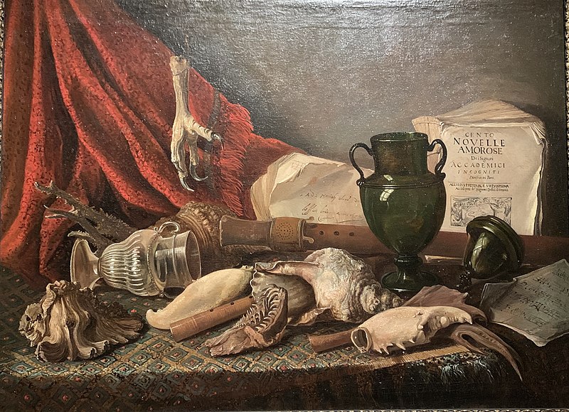 Still life on a draped table with music instruments, musical scores, a lying vase, a large shell, and the claw of a bird of prey, Adriaen Honich, 1672