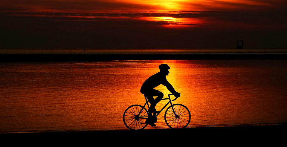 Cyclist Silhouette at Sunset. Free illustration for personal and commercial use.