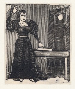 A woman in a prison raising one with one hand on a book and the other raised MET DP869368