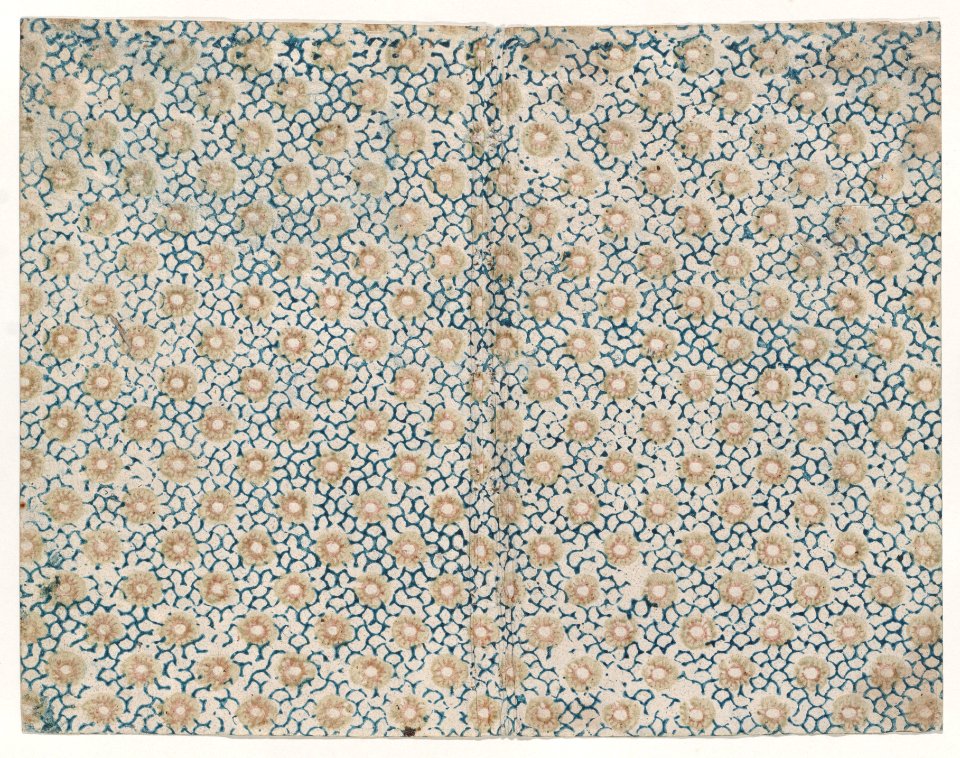 Book cover with yellow floral pattern atop blue curved lines Met DP886792
