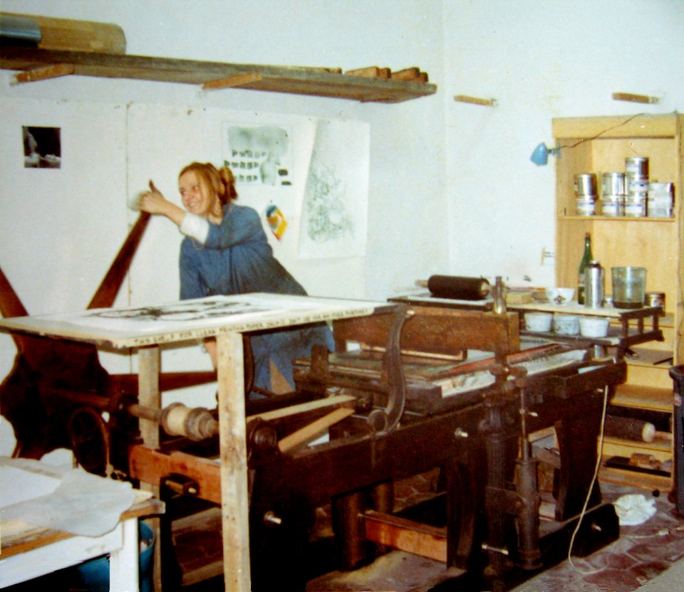 A student turns the litho press and prints a stone in 1970…