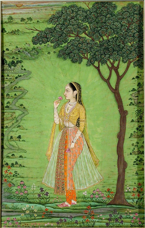 A woman standing by a tree, holding a flower (6124542297)