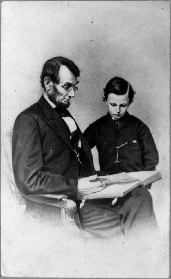 Abraham Lincoln and his son Tad looking at an album of photographs LCCN2009630681