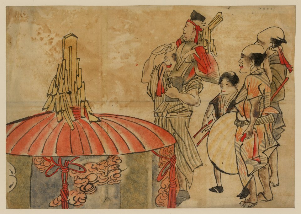 Actors or musicians standing next to a large, decorated cylindar with cover; one man is carrying another on his shoulders LCCN2009630003