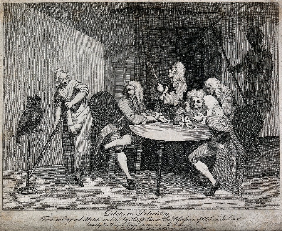 A group of men seated around a table are examining the palm Wellcome V0025922