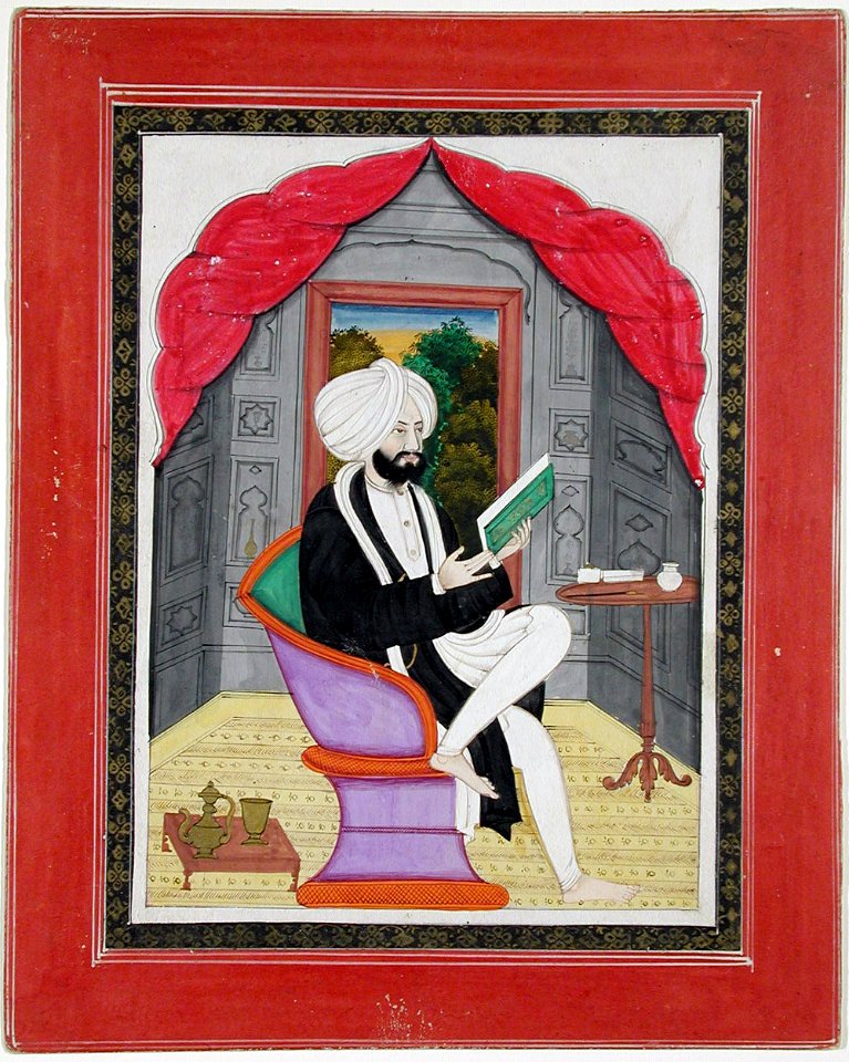 A Sikh Sardar reading from a book, seated in front of a window (6124597647)