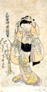 Album page with a woman adjusting a decorative plant ornament in her hair (5758875857)