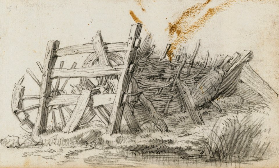 Saftleven Wooden fence and two broken wheels