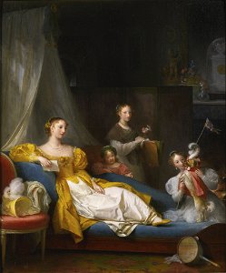 A family in an interior playing with a dog