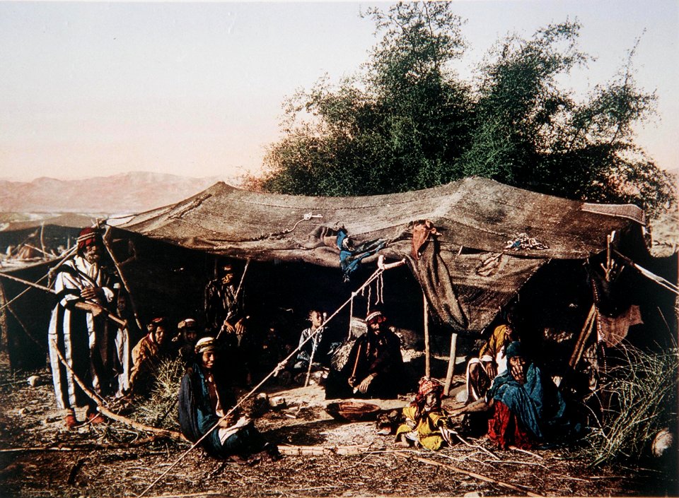 BEDUINS LOUNGING IN THEIR TENT IN GALILEE. COLOR PHOTO TAKEN IN THE LATE 19TH CENTURY BY THE FRENCH PHOTO- GRAPHER OF PEOPLE AND PLACES IN PALESTINE, BONFILS. צילום צבעוני מהמ