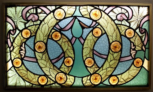 Detail of a window with wreaths of roses, c 1910. Free illustration for personal and commercial use.