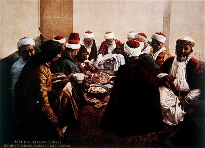 DRUSE RESIDENTS OF THE CARMEL FEAST ON A MEAL OF TRADITIONAL FOODS. COLOR PHOTO TAKEN IN THE LATE 19TH CENTURY BY FRENCH PHOTOGRAPHER, BONFILS. צילום צבע מסוף המאה ה19 של הצלם