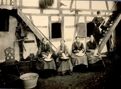 Femmes en costume de travail râpant du raifort Engwiller 1909