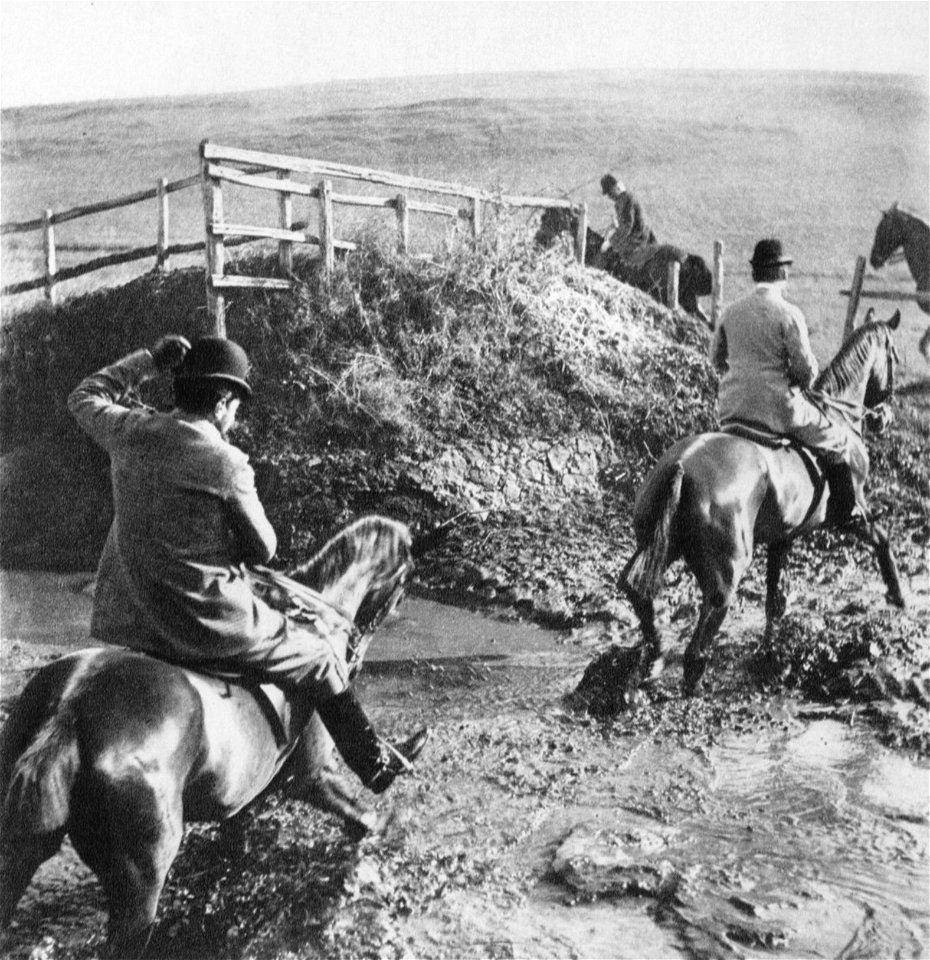 Riders wading through water