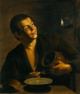 Spanish School - A young man eating by the light of an oil lamp