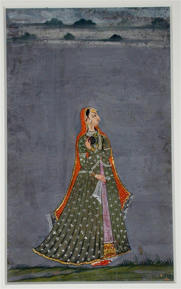 Standing woman in a green dress with a red cloak (6125108576)