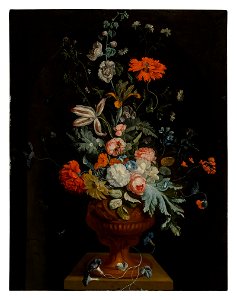 Still life of flowers in a terracotta vase before a stone niche 