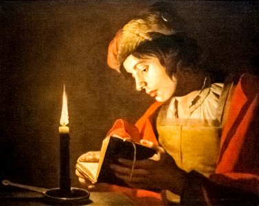 Stom - A Young Man Reading at Candlelight. Free illustration for personal and commercial use.