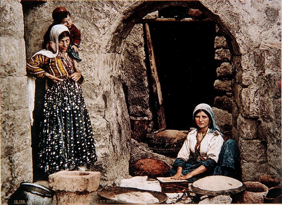 Syrian women baking bread. Colour photo by Bonfils