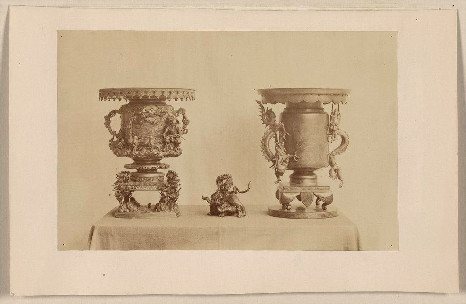 Tall, metal, ornate plant stands and figurine, all with dragon motif, on a table LCCN2009630259