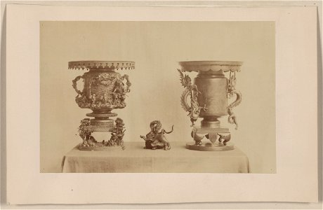 Tall, metal, ornate plant stands and figurine, all with dragon motif, on a table LCCN2009630259