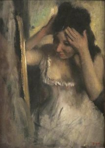 'Woman Combing her Hair before a Mirror' by Edgar Degas. Free illustration for personal and commercial use.