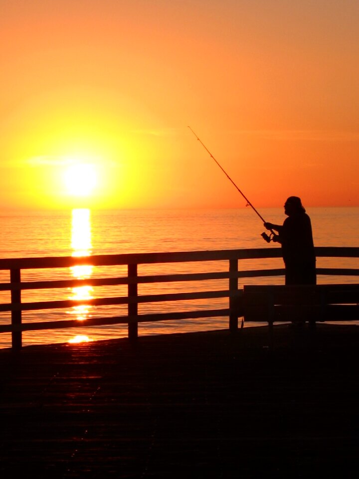 Sunset fisherman sea
