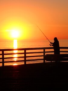 Sunset fisherman sea