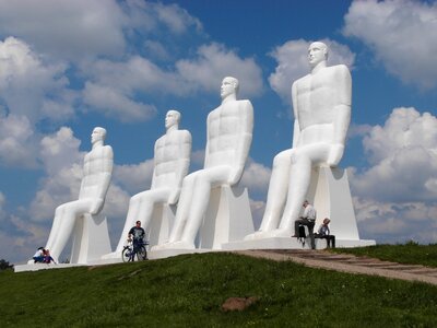 Statues 4 men bicycle