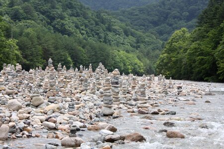 Prayer by the river stone photo