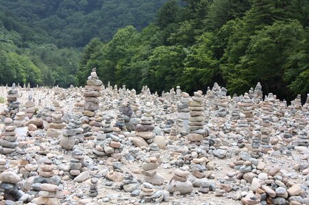 Prayer by the river stone photo