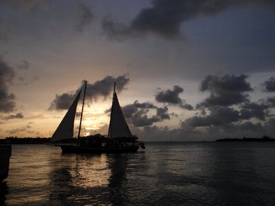Ship sunset clouds sailing boat photo