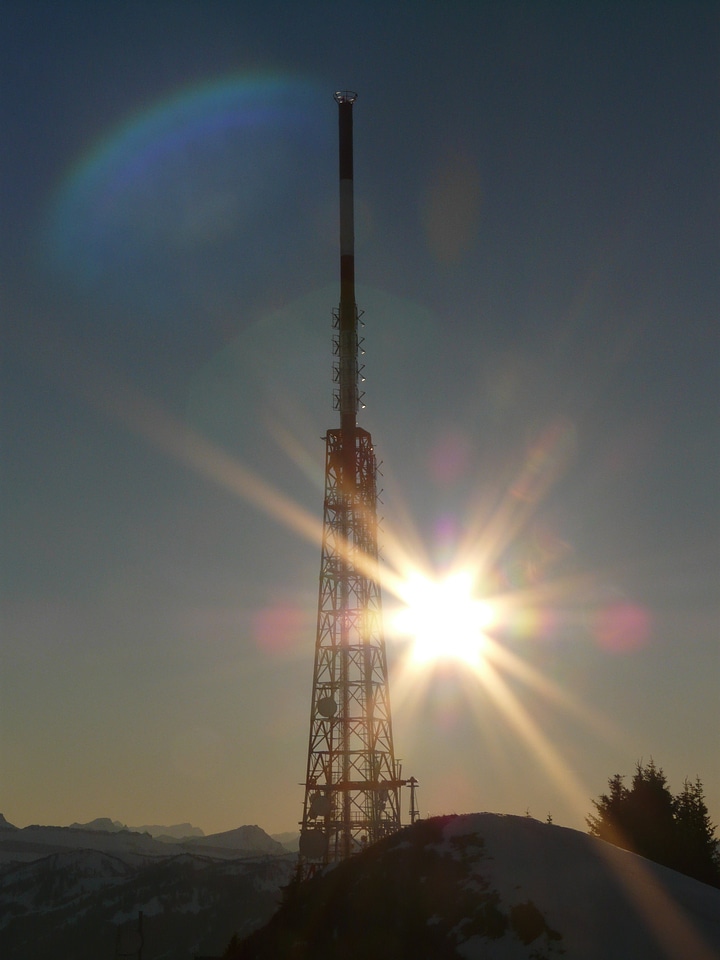 Transmission tower backlighting sun
