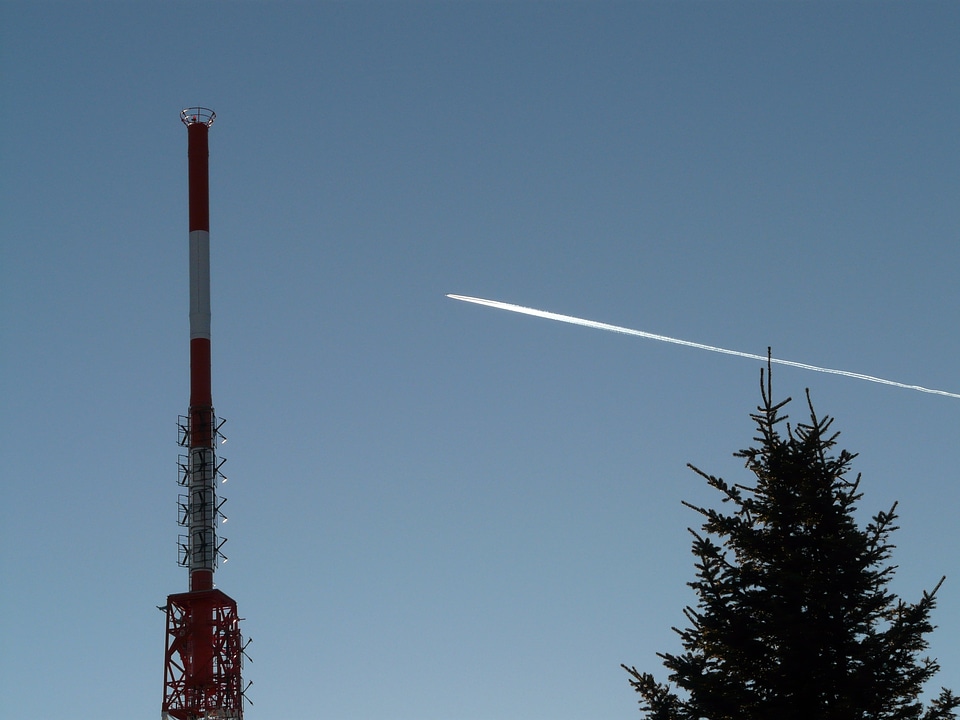 Transmission tower aircraft contrail