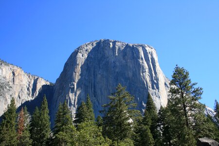 Blue skies trees rock photo