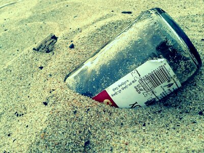 Bottle buried green beach photo