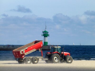 Tractors clean beach summer photo