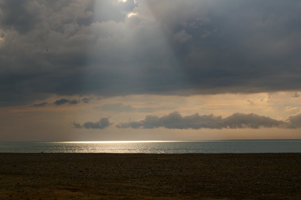 Reflections on the water dark clouds sand