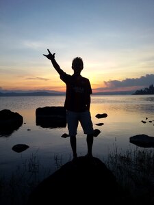 Man siilhouette lake to light photo