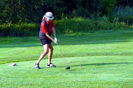 Woman golf ball tee photo