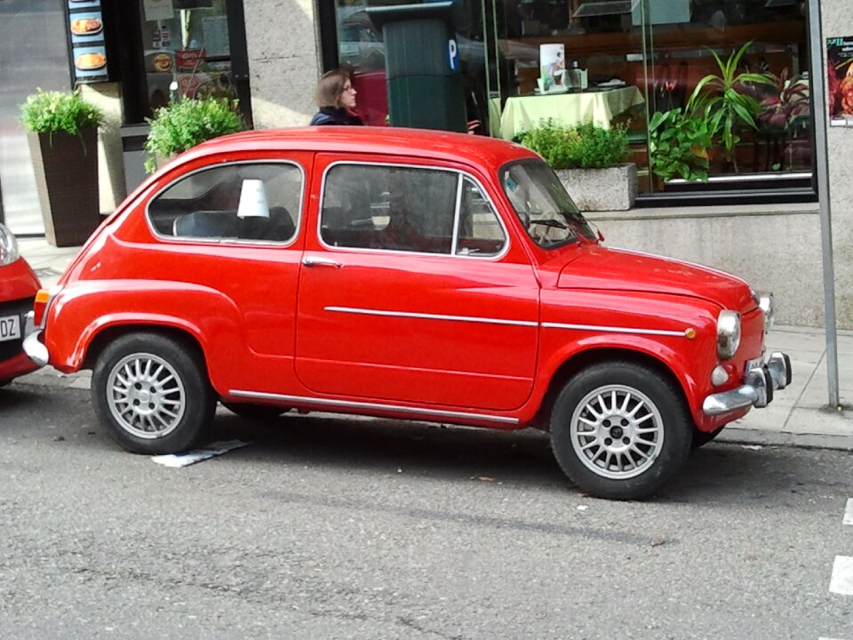 Little car red car street parking