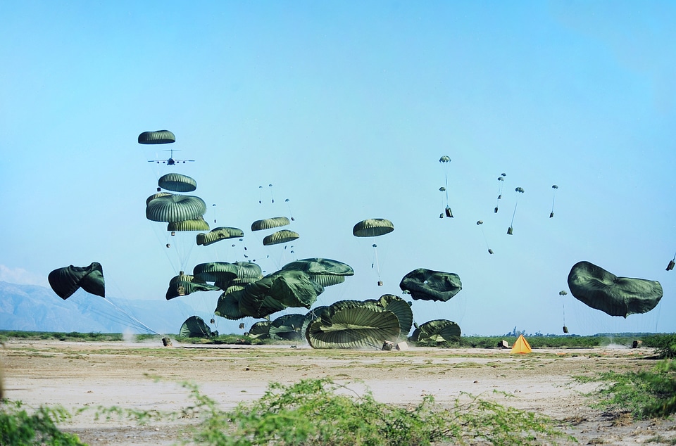 Parachutes rescue packages landing