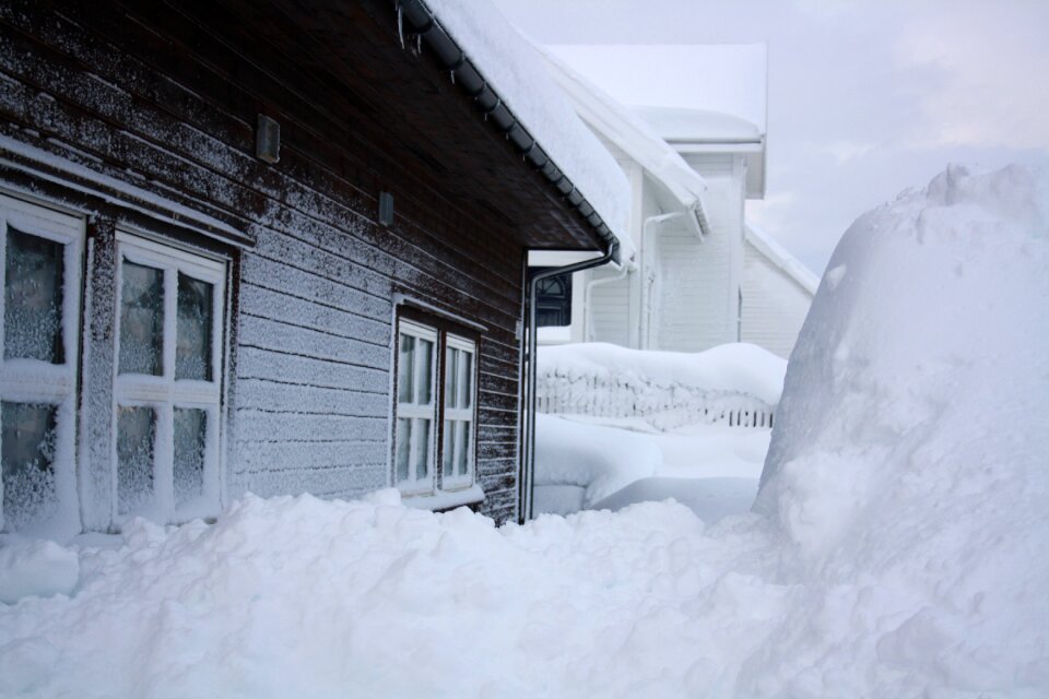 Blizzard snowbound house wall