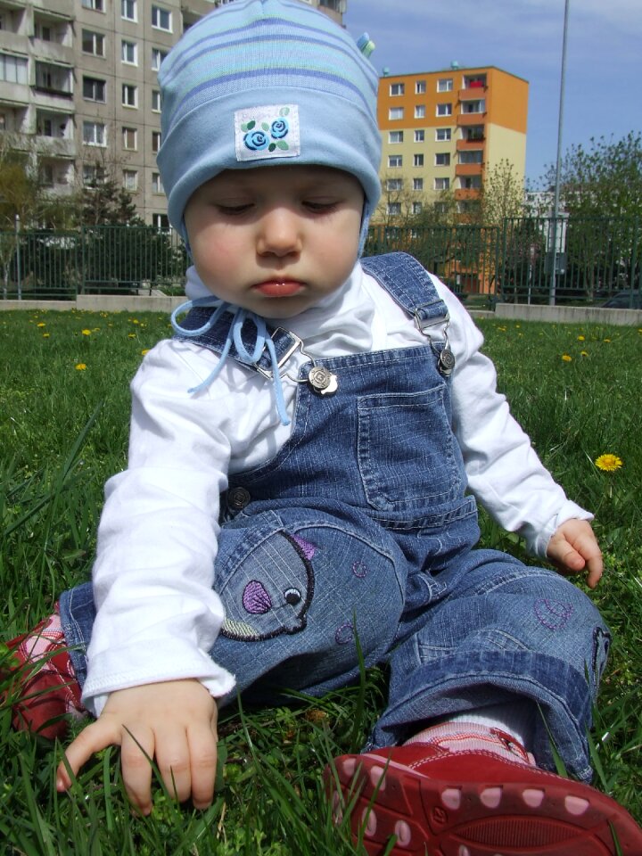 On the grass blue cap sit