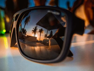 Sunset sunglasses reflection photo