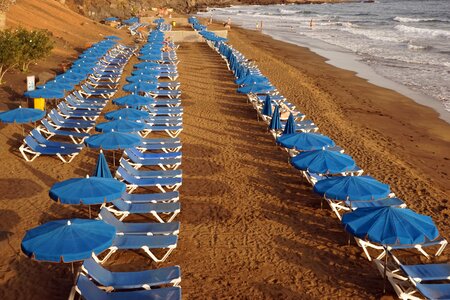 Parasols blue sand beach photo